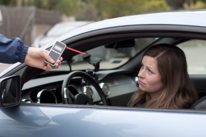 Driver with a breathalyzer test. Learn if a breathalyzer is admissible in court in California.