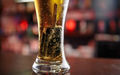 Car key in the glass with beer