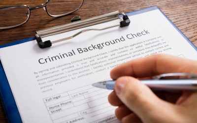 A person fills out a form to authorize a criminal background check.