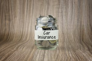 A change jar with a label saying car insurance. You may need to save your dimes like this if a DUI affects your California driver’s insurance for the next 3-5 years.