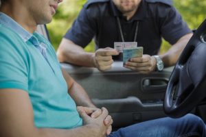 cop inspecting a CA license