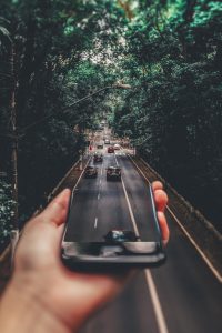 A road coming out of a phone. Find out how you can get your DUI charges reduced in California with a lawyer.