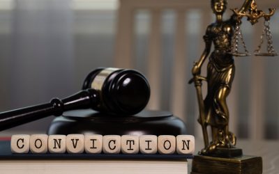 word conviction composed on wooden dice with gavel