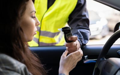 woman taking a breathalyzer