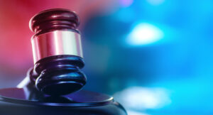 gavel with police lights in the background