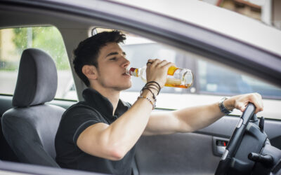 young man drinking while driving