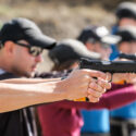 young people learning how to use a firearm