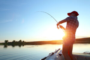 A person fishing. Learn about getting a fishing license with a DUI in California.