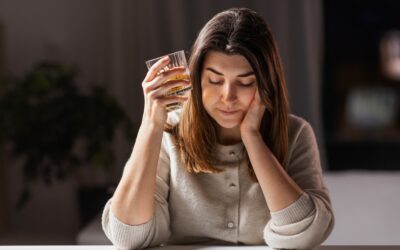 A thoughtful woman with a drink. Find out how DUIs can impact your mental health. 