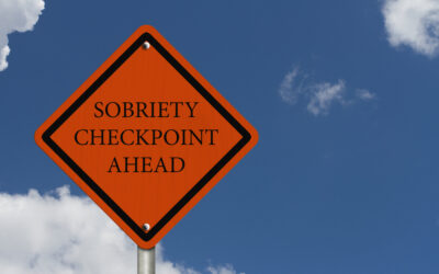 A person considers hiring a lawyer after a DUI checkpoint.