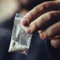 A man holds up cocaine in a bag. How much cocaine is a felony?