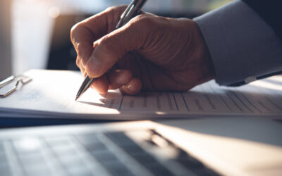 A man fills out paperwork to apply for a restricted license after a DUI. A DUI lawyer in Los Angeles will protect your rights.