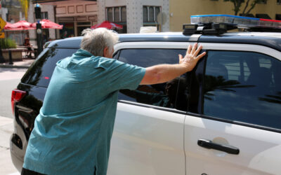 A man getting arrested for a DUI puts his hands on a police car and wonders, “How bad is a DUI?” 