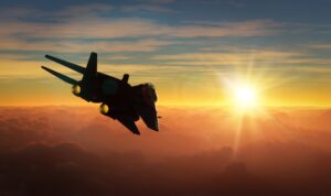 A military jet flies toward the setting sun while onlookers wonder: Can you get promoted in the military with a DUI?