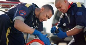 A paramedic helping an injured car accident victim. Can you be a paramedic with a DUI?