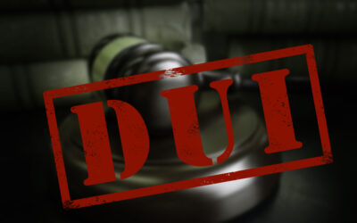A red stamp of “DUI” in front of a judge’s gavel symbolizes the possibility of a DUI making you inadmissible to the U.S.