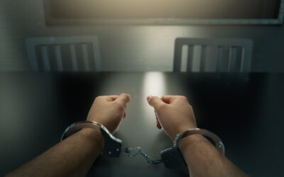Handcuffed man. Learn about the punishment for drunk driving and killing someone.