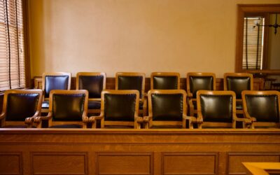 An empty jury box in a courtroom. A lawyer can explain if you can serve on a jury with a DUI.