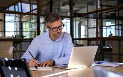 A stockbroker with a DUI is working on his laptop.