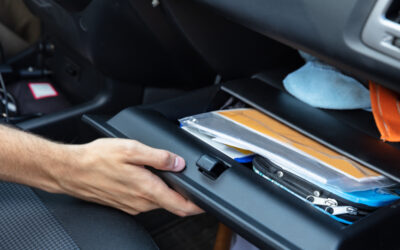 Driver Hand Opening Glovebox Compartment Inside Car searching for their registration after getting a DUI