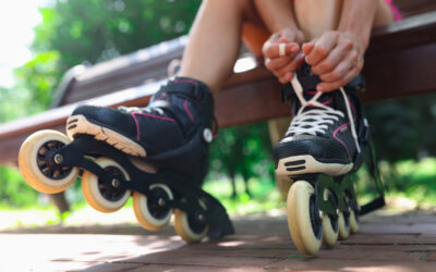 A person lacing up their black rollerblades and wondering if they can get a DUI on rollerblades.