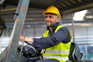 A man driving a forklift. Learn about whether you can drive a forklift with a DUI.