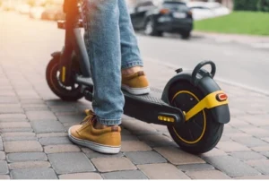A person under the influence of alcohol steps onto an electric scooter. She wonders, “Can you get a DUI on an electric scooter?”