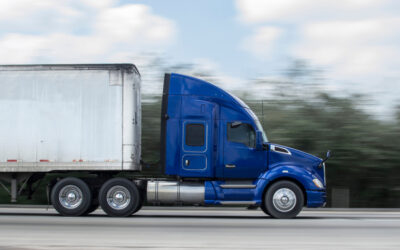 A commercial truck traveling on a highway, with the driver wondering what mistakes they will need to avoid if they have to deal with a commercial DUI charge