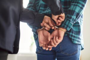 A person in handcuffs after a misdemeanor DUI arrest