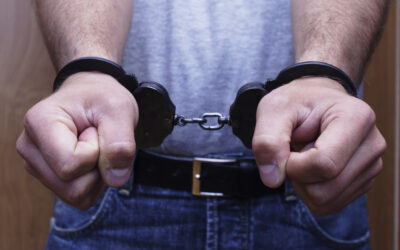 Close-up of a person’s hands in handcuffs following a driving under the influence arrest, with this individual wondering what will happen if they’re convicted of a felony DUI