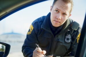 Police officer issuing a ticket at a DUI checkpoint. 12 mistakes to avoid after a DUI checkpoint arrest