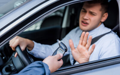 A man declining a breathalyzer test from a police officer. Learn about 5 mistakes to avoid in a DUI refusal case.