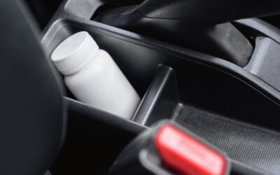 Close-up of a medicine bottle inside a car, using medication before driving concept. 5 mistakes to avoid in a prescription drug DUI case