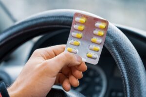 Blister of pills in the hands of a driver. 5 Ways a lawyer can help with a prescription drug dui case.
