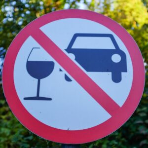 A street sign depicting a car and a wine glass with a red slash through the middle to symbolize the question of how a lawyer can help with a DUI refusal case. 