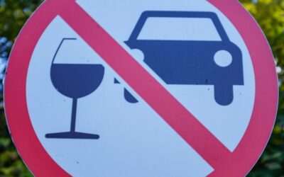 A street sign depicting a car and a wine glass with a red slash through the middle to symbolize the question of how a lawyer can help with a DUI refusal case. 