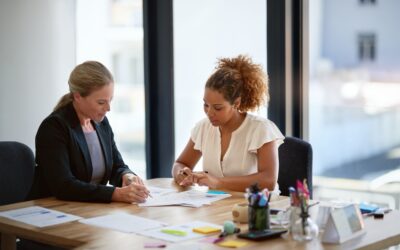 A woman meeting with her attorney. A lawyer can tell you how long a probation officer has to violate you and can help if you face a probation violation.