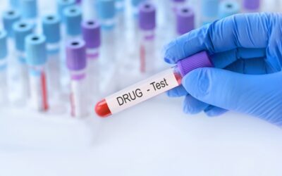 Hand with medical glove of doctor holds test tube with blood sample and blank label for own text on the background of medical test tubes. Do you get drug tested on unsupervised probation in CA?